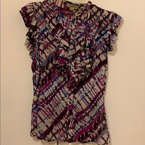 Really cute ruffled light shirt .